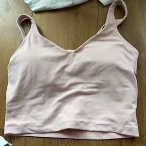 A pink lululemon crop top with a built in bra. Hasn’t been worn